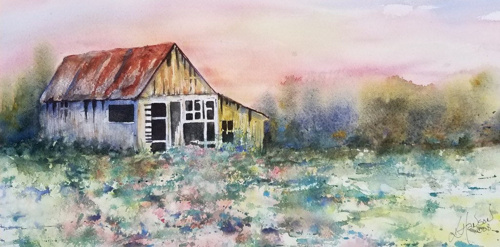 A watercolor painting of an old, weathered barn with a rusty roof sits in a field of colorful wildflowers under a soft, pink and yellow sky at sunset. Trees line the horizon in the background.